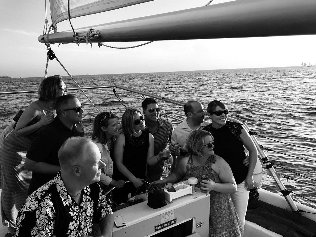 photo of friends looking off into the sunset on Danger Charter's Wine and Sunset Cruise